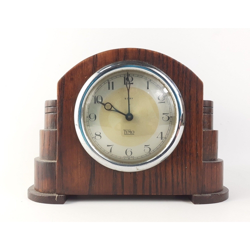 112 - An Art Deco style wooden mantle clock by TYMO. Stands 14cm tall and 18cm across. Winder currently ja... 