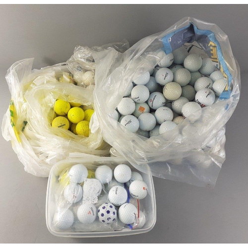 137 - A box containing a substantial collection of used but in good condition golf balls to include many T... 