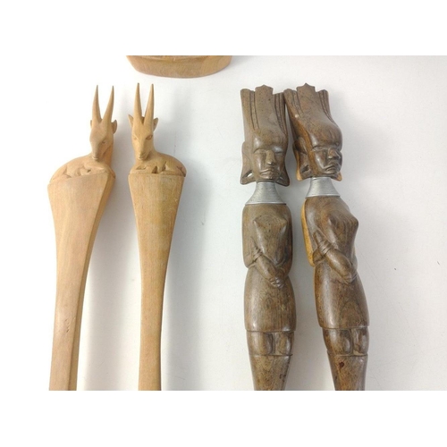 227 - Two pairs of wooden African salad servers one pair with antelopes (33cm long), the other with stern ... 