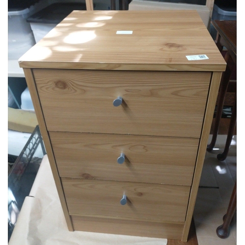 428 - A modern three drawer bedside cabinet in light wood finish.  Stands 60cm tall and in good order.#133... 