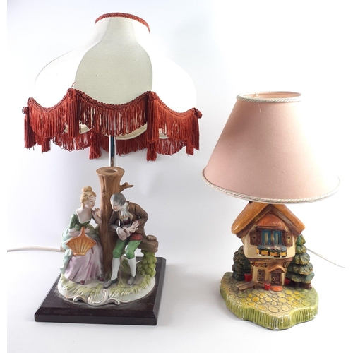 466 - Two quaint ceramic lamps with lampshades to include a courting couple sitting next to a tree measuri... 