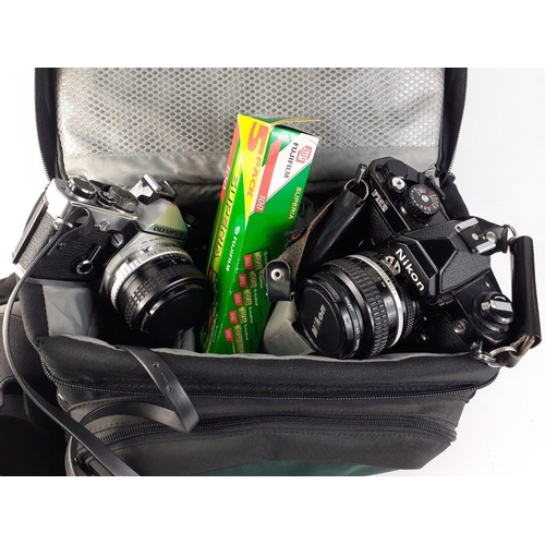 143 - A CANON EOS 1000F camera in carry case, a NIKON FM2 camera in a LOWEPRO padded case with also an OLY... 