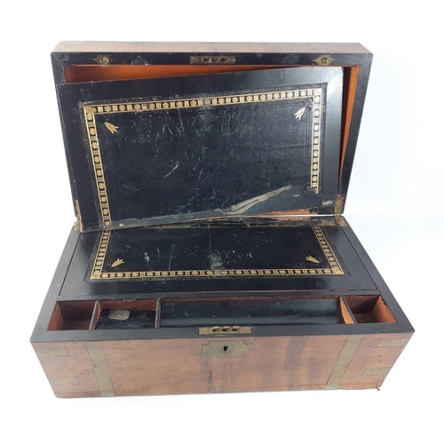 229 - A 19th century wooden writing slope with brass banding and escutcheon. The interior of the box is in... 