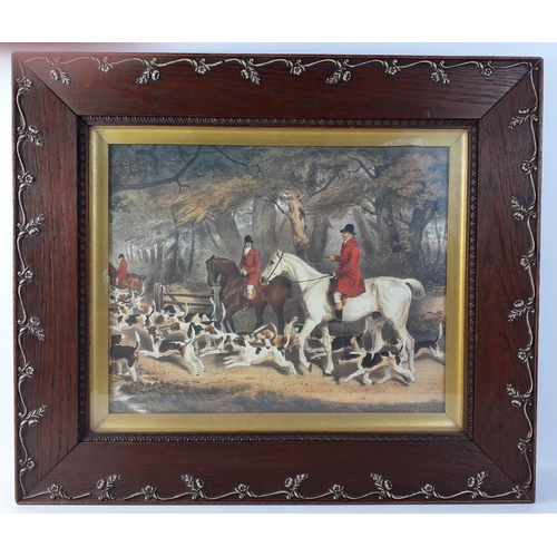 403 - A hunting scene print in an ornate wooden frame with gilt highlights, frame size 55cm x 47cm, visibl... 