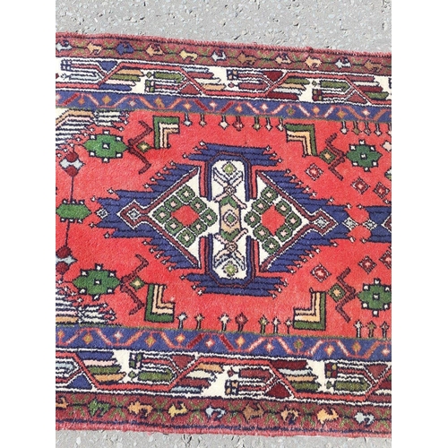 338 - A hand made Persian woollen runner carpet. measures 82cm wide and 250cm long.#92