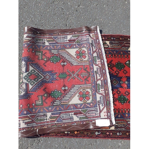 338 - A hand made Persian woollen runner carpet. measures 82cm wide and 250cm long.#92