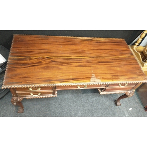 362 - A low wooden desk with central drawer, 2 sets of 2 side drawers all on ball and claw feet. Approx 16... 