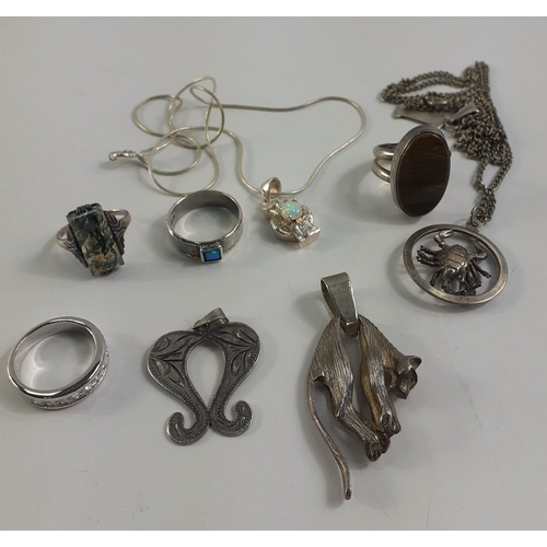 42 - A small bag of assorted 925 stamped silver to include a leopard pendant, and a lobster pendant on ch... 