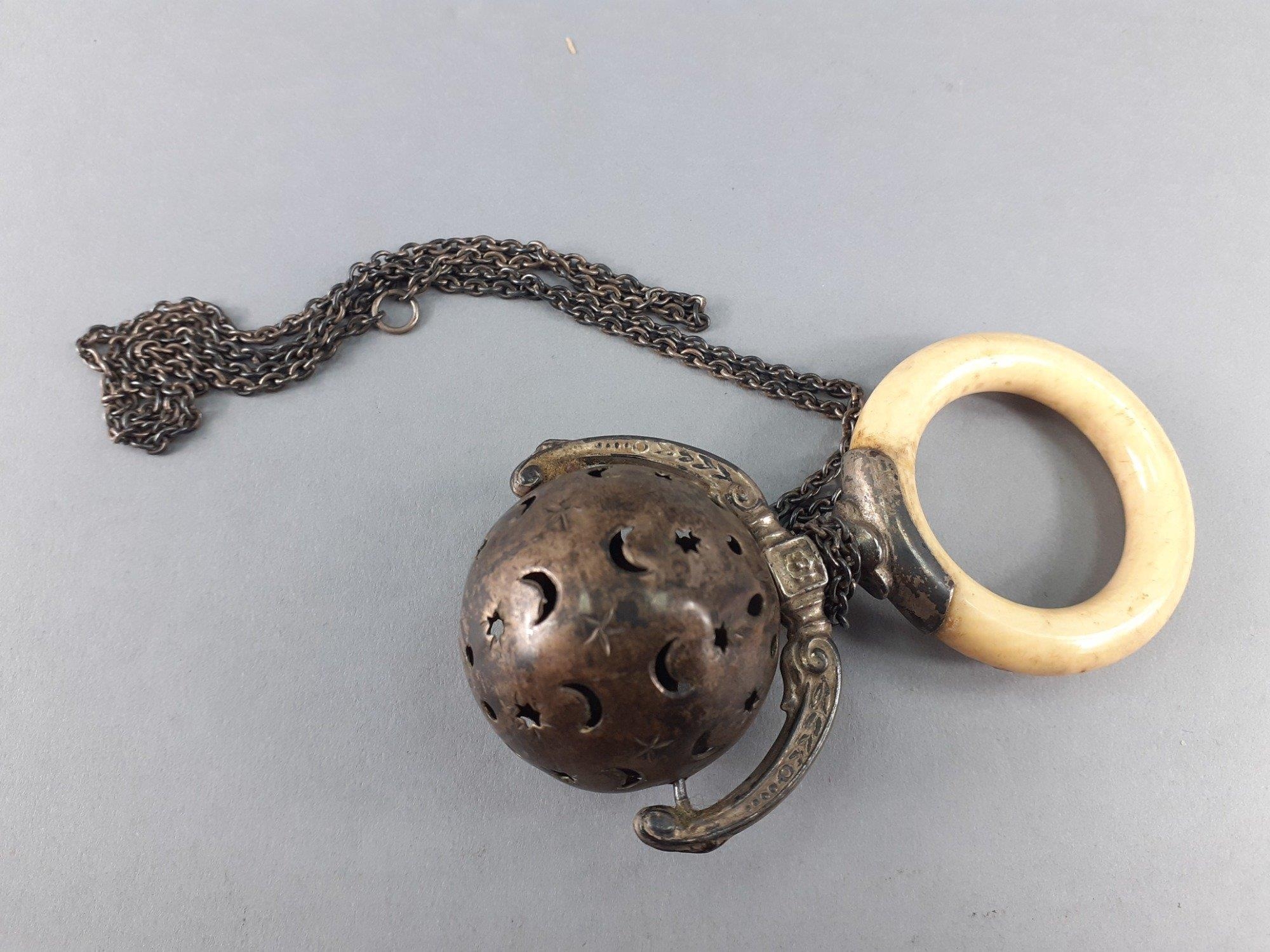 A Victorian child's rattle and teether with chain. Slight dents but a ...