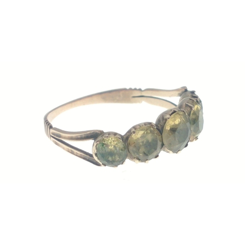 15 - An unmarked ‘yellow metal' ring size N/O with five greenish coloured stones gross weight 1.67g... 