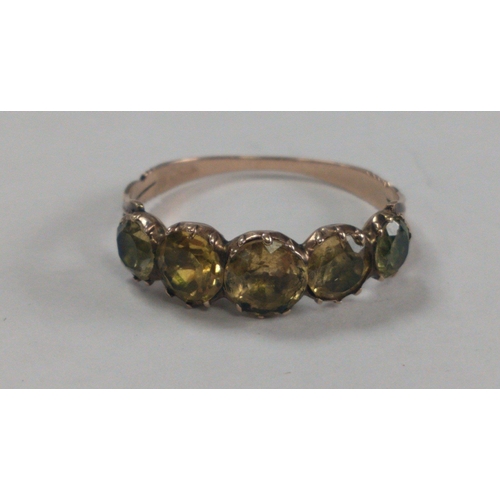 15 - An unmarked ‘yellow metal' ring size N/O with five greenish coloured stones gross weight 1.67g... 