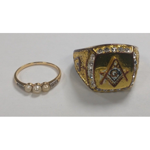 16 - A large gaudy MASONIC symbol ring size Z and one other unmarked yellow metal ring with three seed pe... 