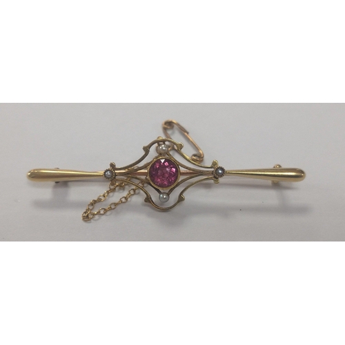 18 - Yellow metal bar brooch stamped 15ct with pink centre stone and four seed pearls and safety chain. 5... 