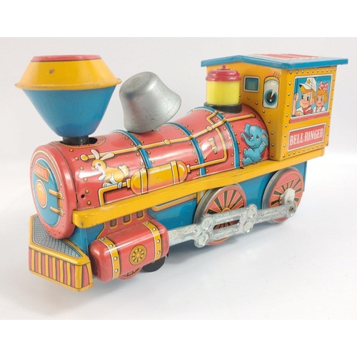 210 - TM TOYS, tinplate battery locomotive and two other modern clockwork toys in plastic inner packaging,... 