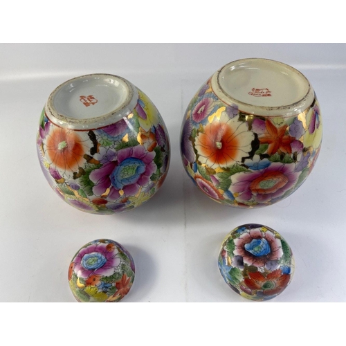 233 - A near pair of Chinese hand-painted lidded ginger jars with colourful flora decoration and gilt acce... 