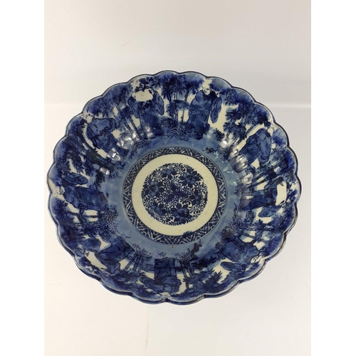 247 - A lovely blue and white Oriental bowl with fluted edges and a design of old gentlemen both inside an... 