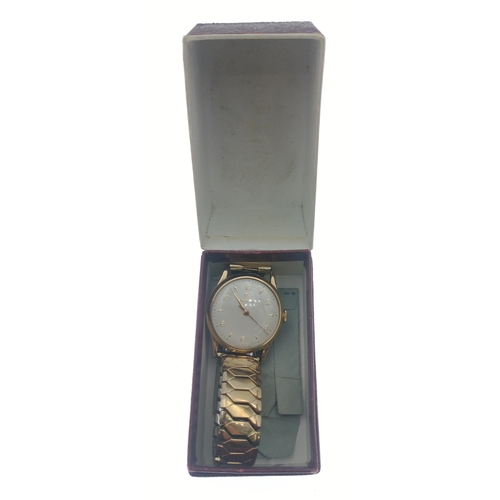 31 - A RECORD gold cased gents wristwatch with 1957 inscription on case.  Plated elasticised band.  Worki... 