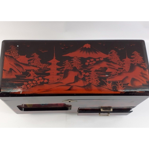 41 - A lovely Oriental Chinese style lacquered jewellery box. 34 x 14 x 20cm approx.  Has a see through p... 