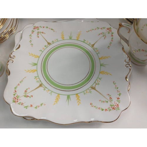 410 - A ROSLYN hand-painted tea service comprising 12 cups, 12 saucers, 12 side plates, 2 cake plates, 1 m... 