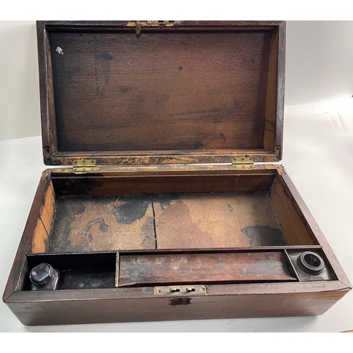 440 - An antique wooden writing box in well used condition internally but retains brass corners.  A good c... 