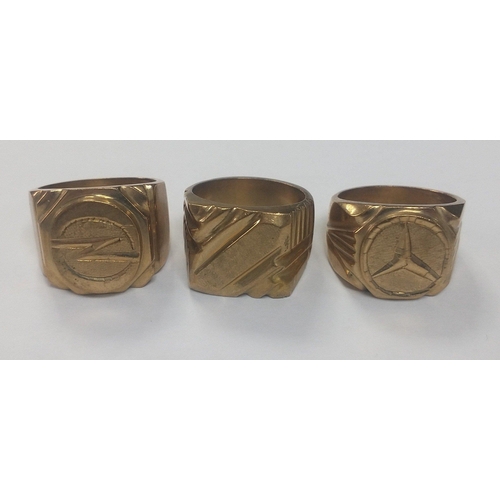 45 - Three chunky gents rings. Yellow metal each stamped 18K 750 but believed brass.  Two with COLLECTABL... 