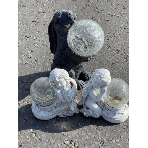 623 - Three garden resin statues,  two in classical cherub form and another in bunny form - largest stands... 