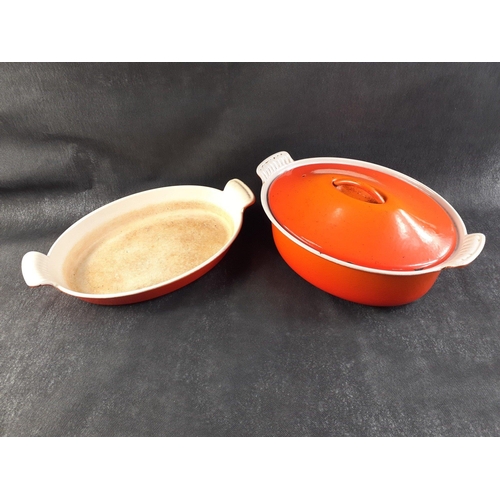 642 - A well-used lidded orange cast iron casserole dish approx 30cm x 20x10cm, (a few small chips in rim)... 