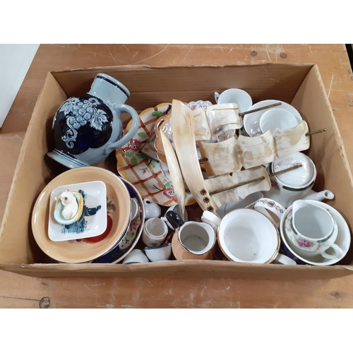 654 - A mixed box of ceramic and other items to include pretty decorated plates, a beautiful wee cat in ba... 