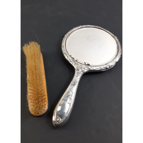 95 - A SILVER backed dressing table mirror with embossed loving couple on the back, hallmarked Birmingham... 