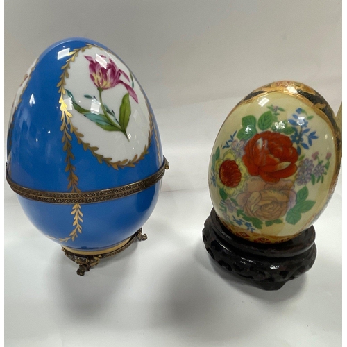 228 - Two DECORATIVE eggs on stands, one with gilt highlights stands approx 11cm high, the other, a large ... 
