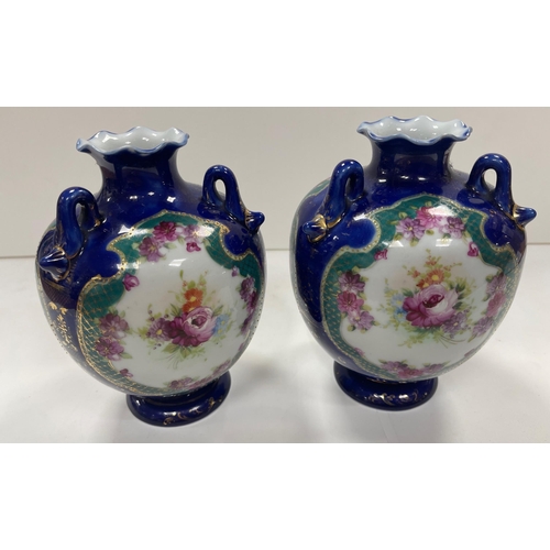 243 - A pair of vintage Oriental vases with a floral and gilt decoration, each stands approx 29cm high.  N... 