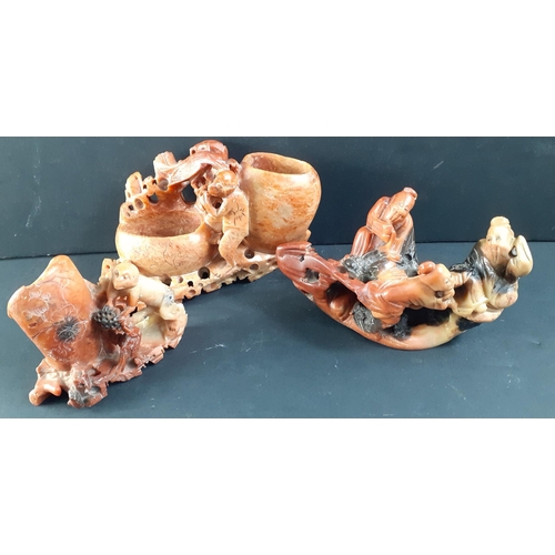 278 - A box of carved CHINESE red soapstone pieces.  Most pieces are carved with monkeys, pots (maybe for ... 