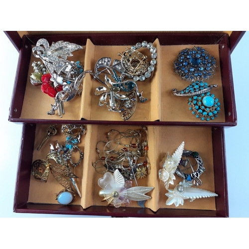 47 - A two tier jewellery box with pull-out drawer complete with contents of brooches of all shapes and s... 