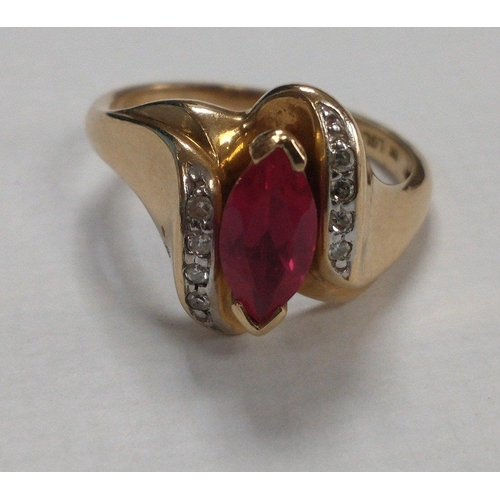 6 - A 10ct stamped yellow gold ring (ring size M/N) with a large oval shaped ruby flanked by 8 small dia... 