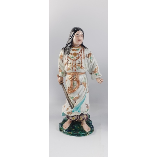 375 - An unusual Oriental warrior with gilt highlights, standing approx 35cm tall#90