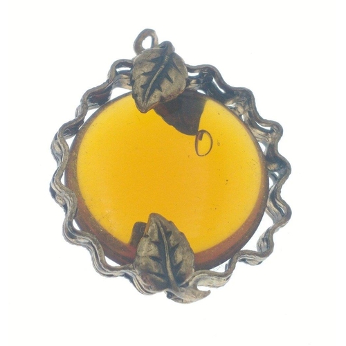 11 - A vintage pendant with an amber bead 20mm x20mm set in a yellow metal surround held in with 4 leaves... 