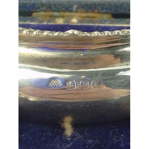 51 - A rather pretty cased set of two SILVER salts with two silver condiment spoons.  One blue glass line... 