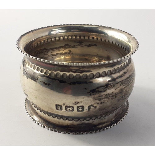 53 - A silver hallmarked bangle with safety chain, (Chester? 1956) weight 7g approx, and a silver napkin ... 