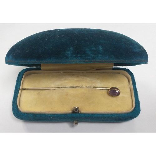 7 - A super little Victorian velvet case with an unmarked yellow metal gents stick pin with amethyst cen... 