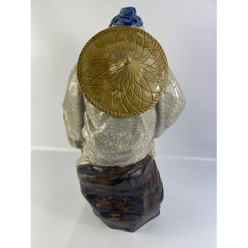 194 - A striking large vintage SHIWAN MUDMAN with crackle glaze finish sitting on a rock standing approx 4... 