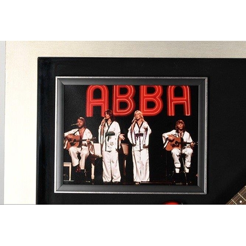 100 - A stunning framed item of ABBA memorabilia which has incorporated within the large box frame a guita... 