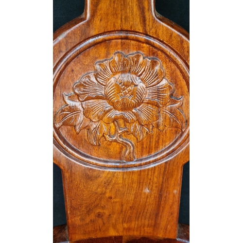 108 - A handmade solid Rosewood swivel chair with hand carving. The feet have castors and the swivel mecha... 