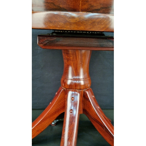 108 - A handmade solid Rosewood swivel chair with hand carving. The feet have castors and the swivel mecha... 