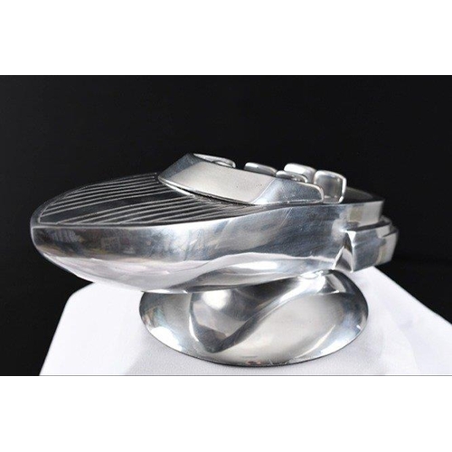 133 - A highly polished aluminium speed boat on base.. H: 16cm  W: 46cm  D: 22cm#133