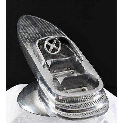 133 - A highly polished aluminium speed boat on base.. H: 16cm  W: 46cm  D: 22cm#133