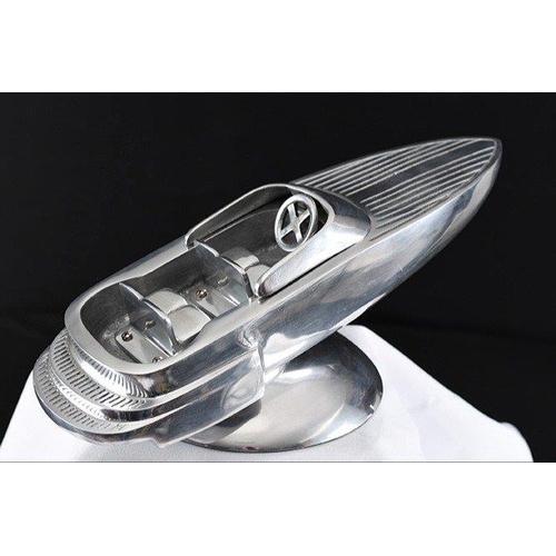 133 - A highly polished aluminium speed boat on base.. H: 16cm  W: 46cm  D: 22cm#133