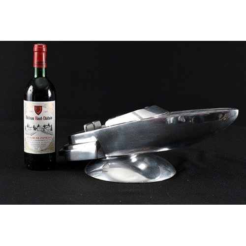 133 - A highly polished aluminium speed boat on base.. H: 16cm  W: 46cm  D: 22cm#133