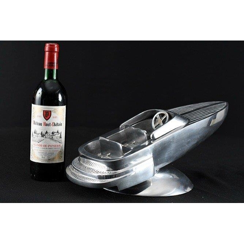 133 - A highly polished aluminium speed boat on base.. H: 16cm  W: 46cm  D: 22cm#133