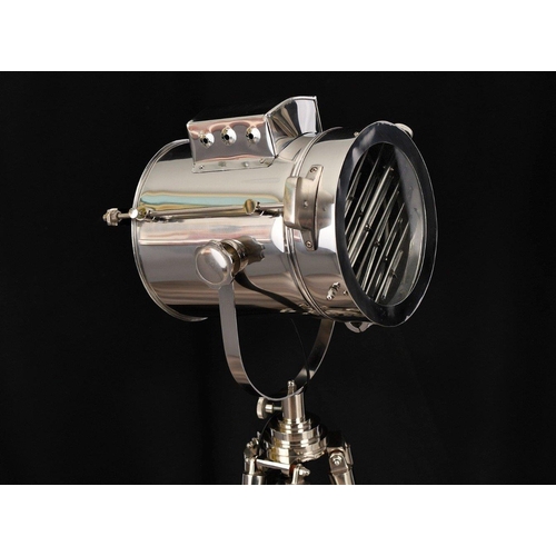 152 - A fully adjustable metal spotlight with wooden legs. The height of the legs can be adjusted and scre... 