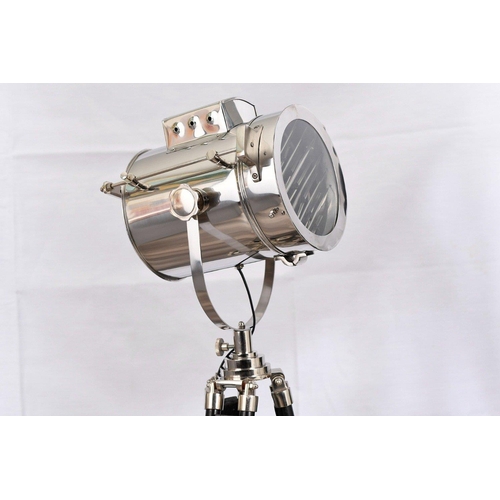 152 - A fully adjustable metal spotlight with wooden legs. The height of the legs can be adjusted and scre... 